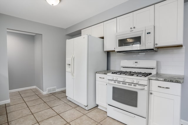 kitchen with white appliances, light tile patterned floors, visible vents, decorative backsplash, and white cabinets