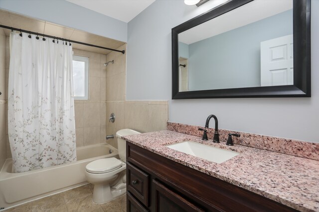 bathroom with toilet, vanity, and shower / bath combo