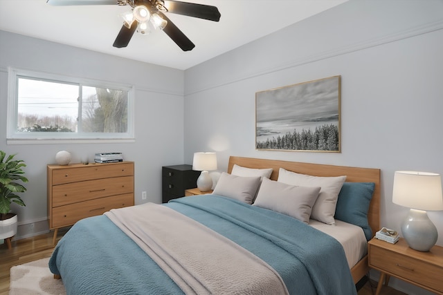 bedroom featuring wood finished floors and ceiling fan