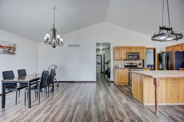 dining area with dark wood-style floors, visible vents, baseboards, high vaulted ceiling, and a chandelier