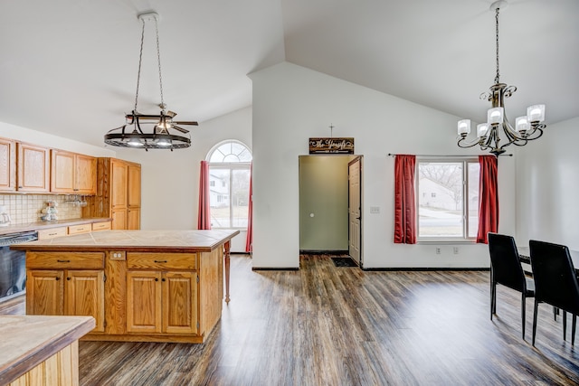 kitchen featuring backsplash, decorative light fixtures, black dishwasher, vaulted ceiling, and dark wood-style flooring