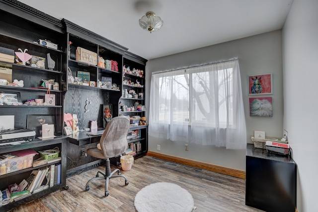 home office featuring baseboards and wood finished floors