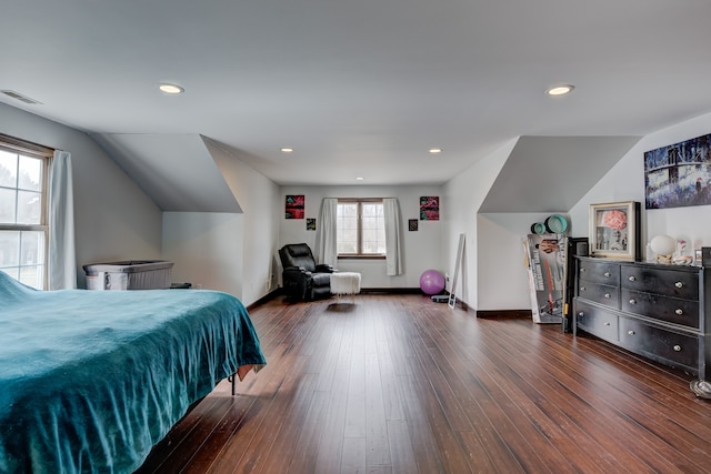 bedroom with hardwood / wood-style floors, baseboards, visible vents, lofted ceiling, and recessed lighting