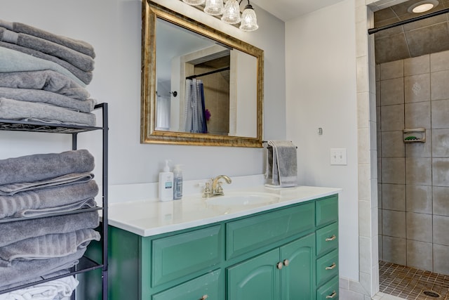 full bath featuring vanity and tiled shower