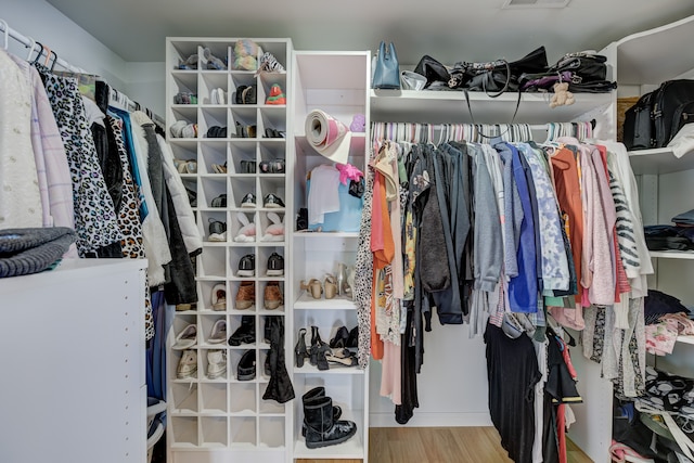 walk in closet featuring wood finished floors and visible vents