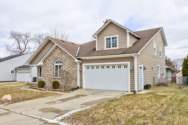 view of front of home featuring brick siding, a front lawn, fence, roof with shingles, and driveway