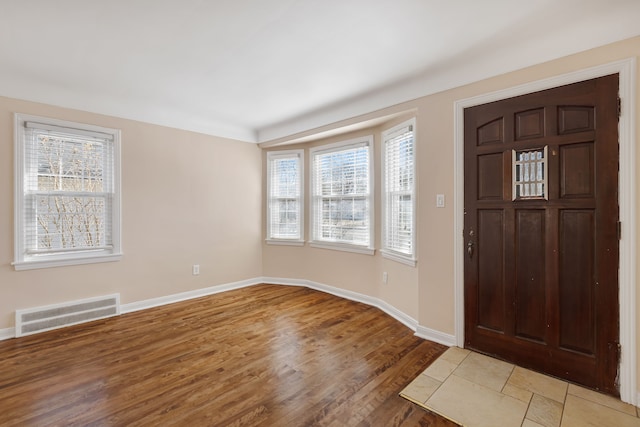 entryway with visible vents, baseboards, and light wood finished floors