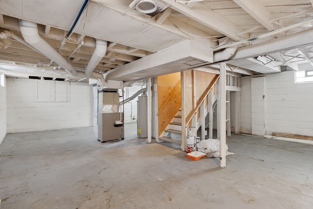 below grade area with stairs and heating unit