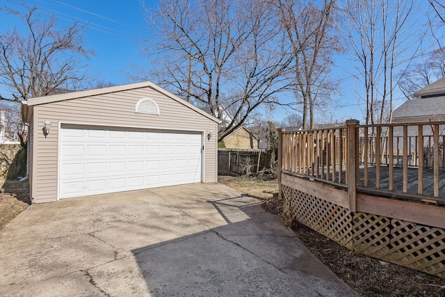 detached garage featuring fence