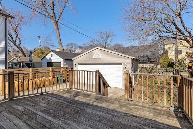 wooden deck with a garage and an outdoor structure