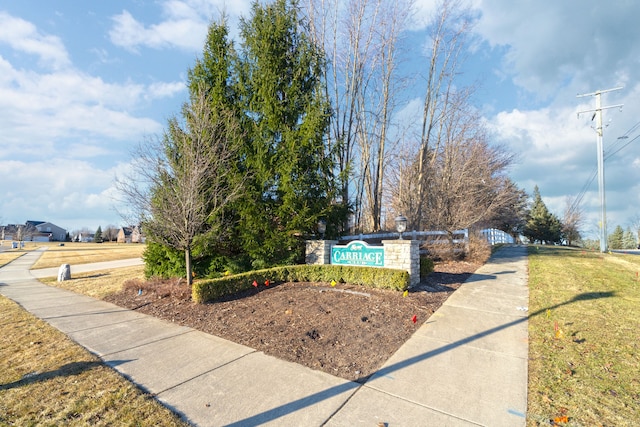 community sign featuring a lawn