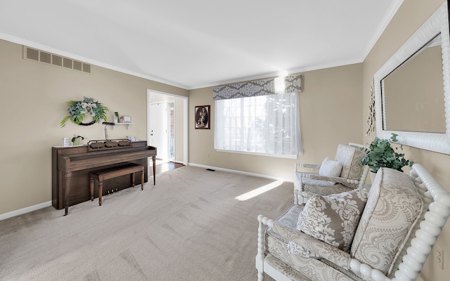 sitting room with visible vents, crown molding, baseboards, and carpet floors