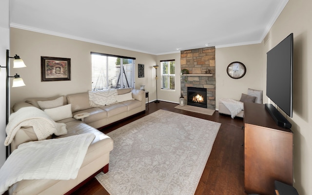 living room featuring visible vents, a fireplace, dark wood-style flooring, and ornamental molding