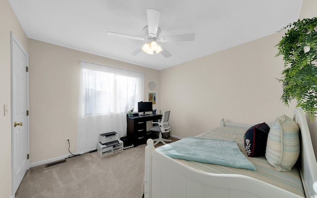 bedroom with visible vents, baseboards, light colored carpet, and a ceiling fan