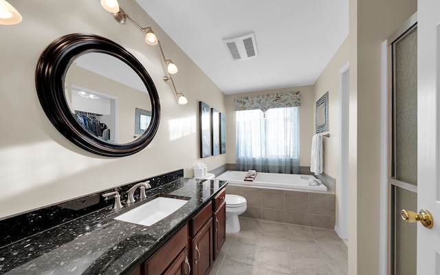 bathroom with tile patterned floors, visible vents, a garden tub, toilet, and vanity