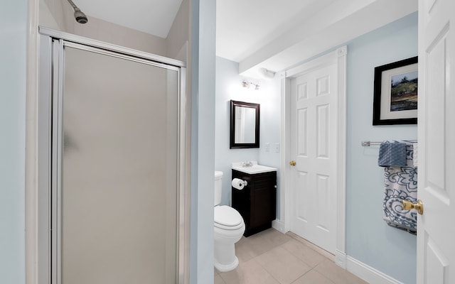 full bath featuring vanity, baseboards, a stall shower, tile patterned flooring, and toilet