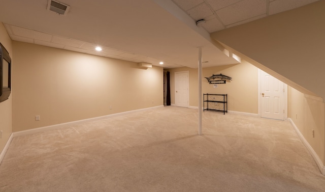 finished below grade area featuring visible vents, carpet floors, and baseboards