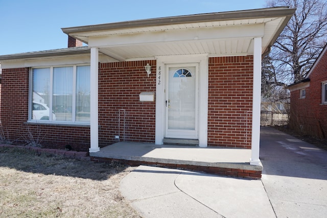 entrance to property with brick siding