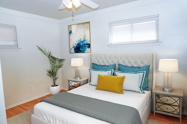 bedroom featuring a ceiling fan, wood finished floors, and baseboards