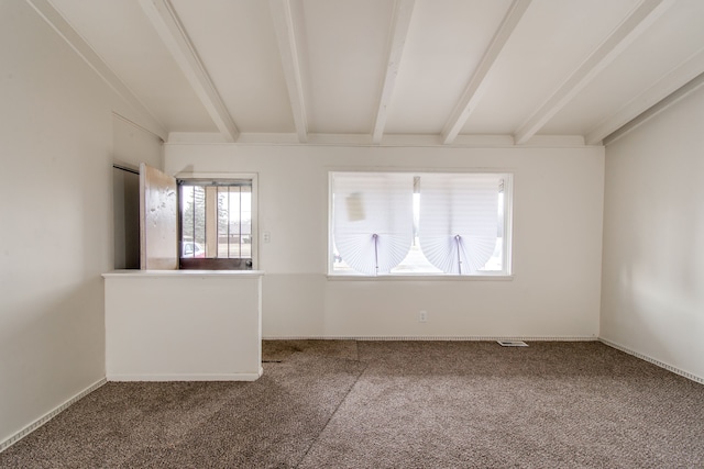 spare room featuring beam ceiling, visible vents, and carpet floors