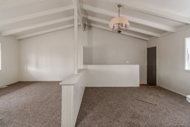 carpeted spare room featuring vaulted ceiling with beams and a chandelier