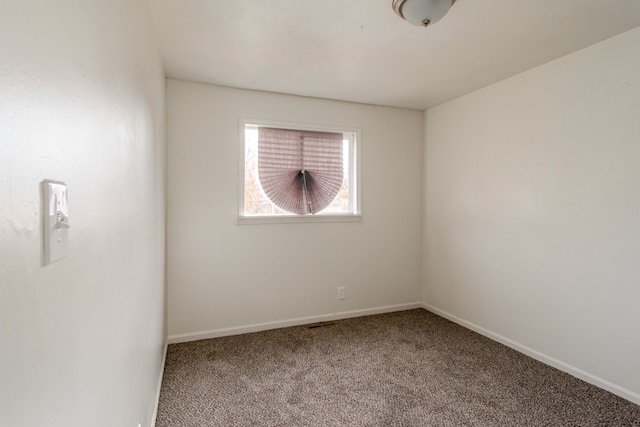 carpeted spare room with baseboards