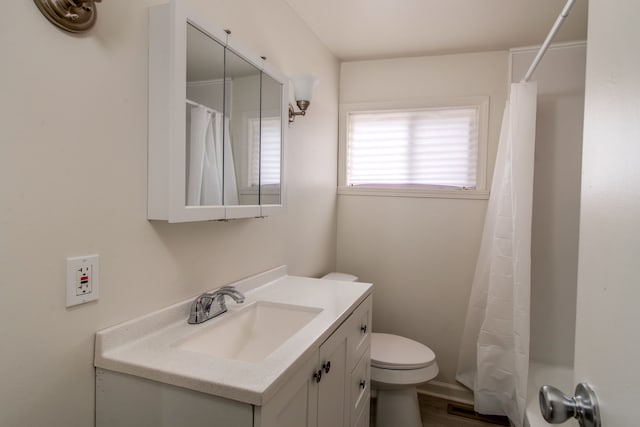 full bathroom with toilet, vanity, and a shower with curtain