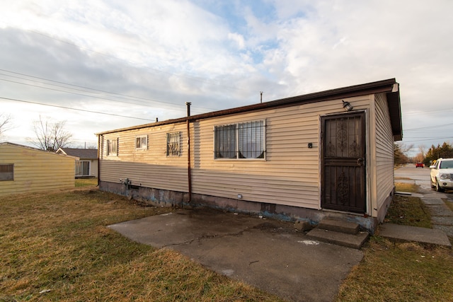 back of house with a lawn