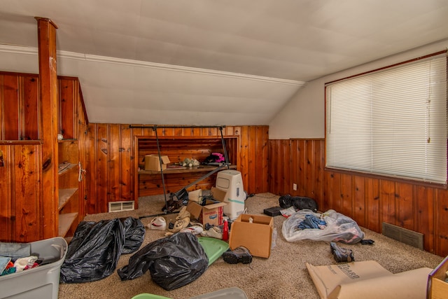 bonus room with wooden walls, carpet floors, visible vents, and vaulted ceiling