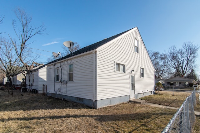 view of side of property with a yard and fence