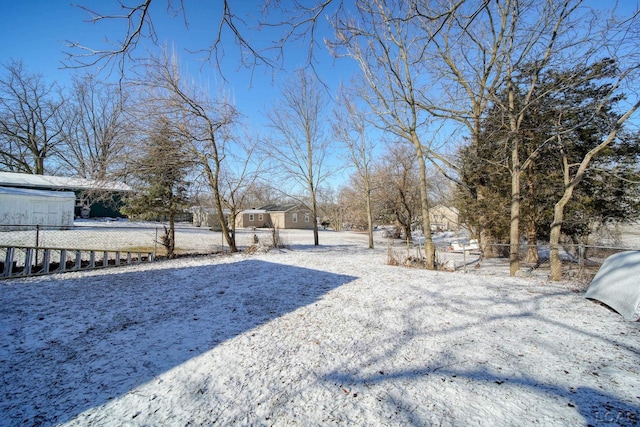 snowy yard with fence