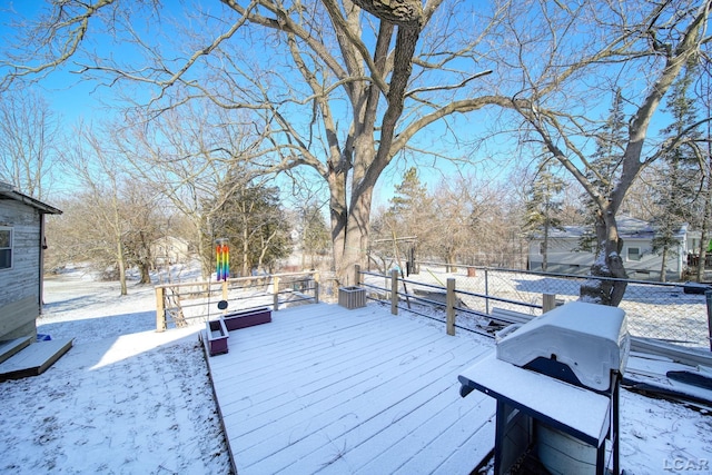 snow covered deck featuring a grill