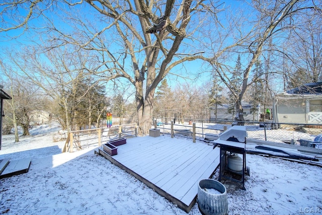 snow covered deck featuring a grill