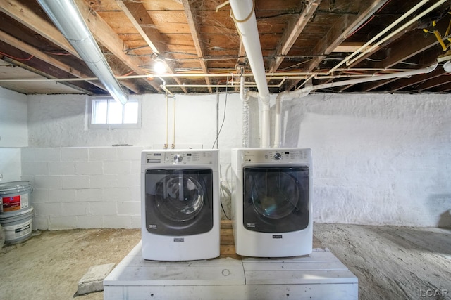 clothes washing area with washer and clothes dryer and laundry area