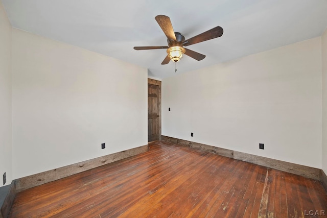 spare room featuring baseboards, ceiling fan, and wood-type flooring