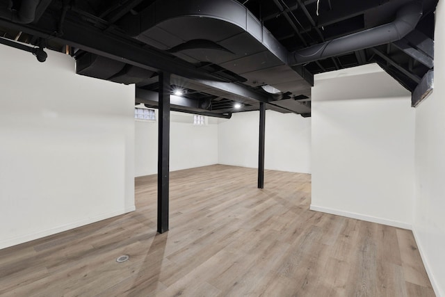 finished basement featuring baseboards and wood finished floors