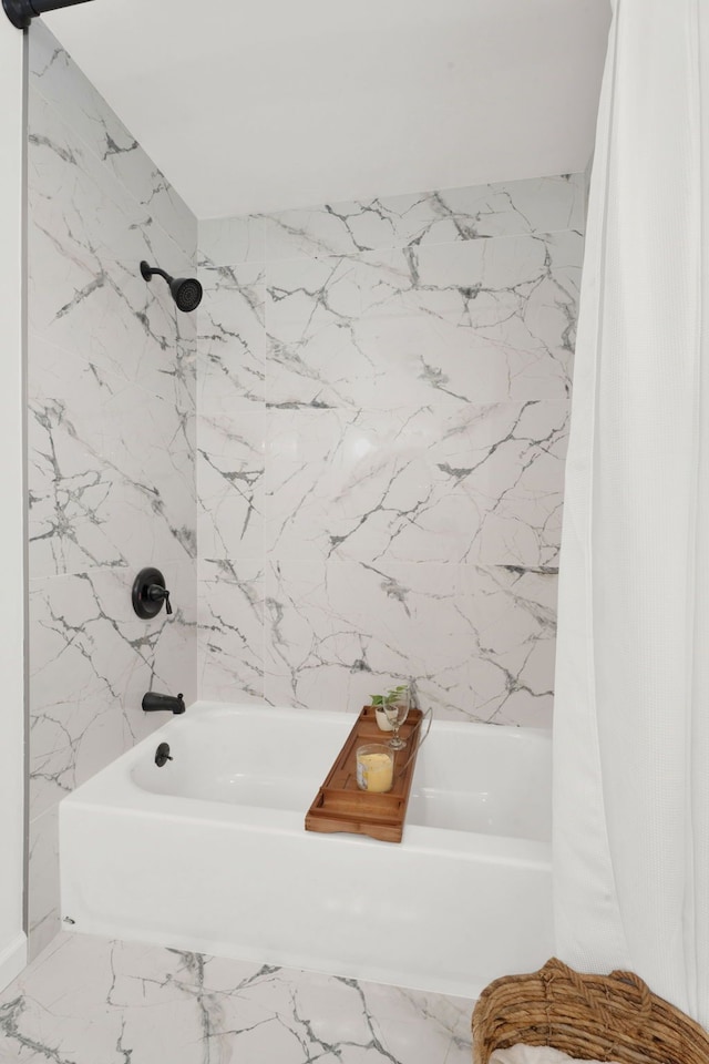 bathroom with marble finish floor and shower / bath combination with curtain