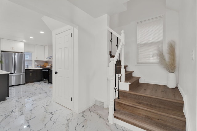 interior space featuring recessed lighting, visible vents, baseboards, and marble finish floor