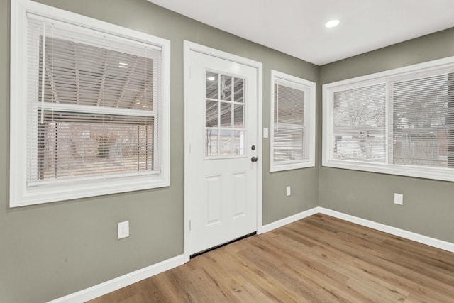 doorway featuring recessed lighting, baseboards, and wood finished floors