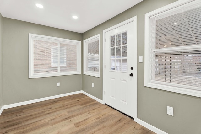 doorway to outside with a wealth of natural light, baseboards, wood finished floors, and recessed lighting