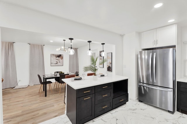 kitchen featuring dark cabinetry, recessed lighting, freestanding refrigerator, light countertops, and white cabinets