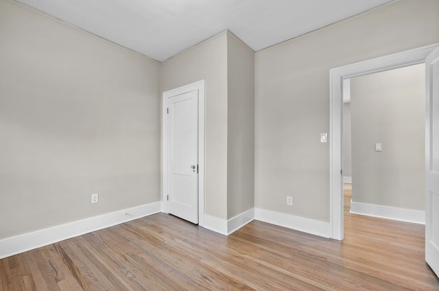 unfurnished bedroom featuring light wood-type flooring and baseboards