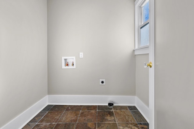 washroom featuring baseboards, stone tile floors, laundry area, hookup for a washing machine, and electric dryer hookup