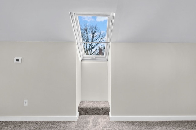 interior space featuring carpet floors and baseboards