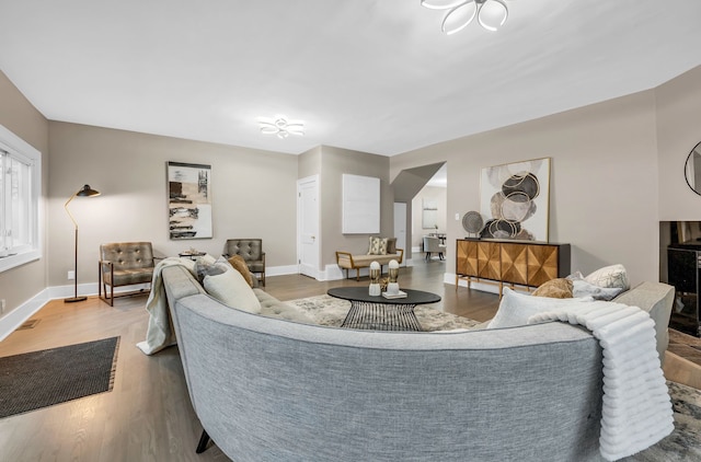 living area featuring baseboards and wood finished floors