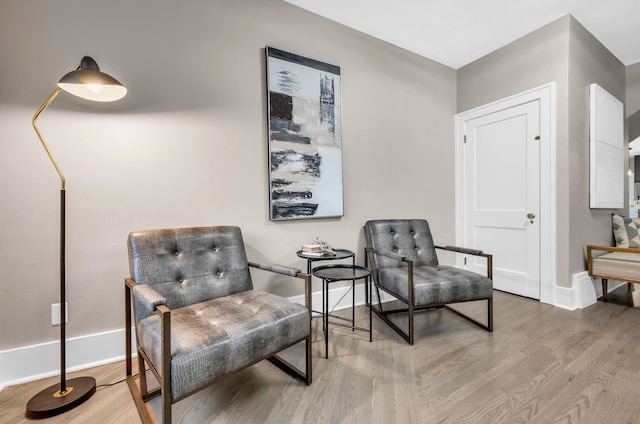 sitting room featuring baseboards and wood finished floors