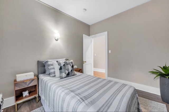 bedroom featuring baseboards and wood finished floors