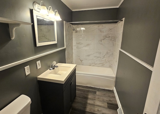 bathroom featuring vanity, wood finished floors, shower / bath combination, crown molding, and toilet