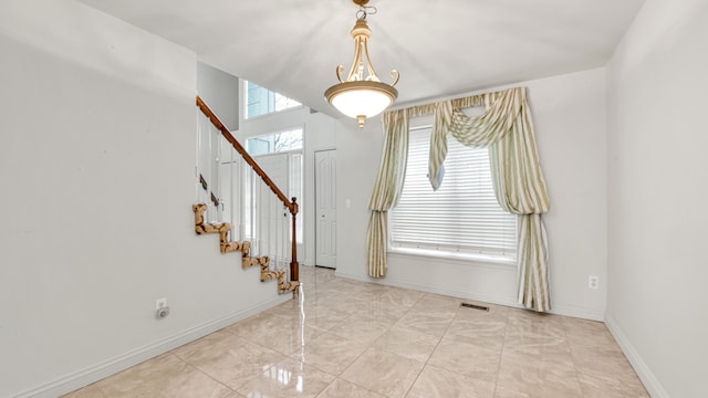 entryway with visible vents, baseboards, and stairs