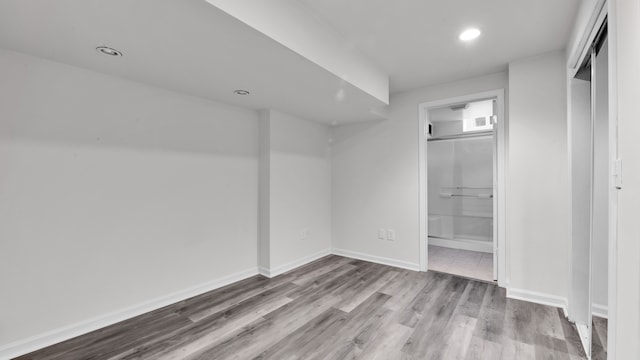 unfurnished bedroom with visible vents, recessed lighting, baseboards, and wood finished floors